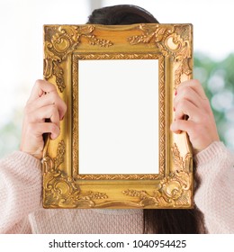 Woman Hiding Face With Picture Frame, Indoors