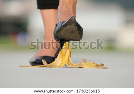 Woman with High Heels Shoes Walking on Banana Peel.