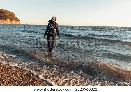 Similar – Image, Stock Photo Young woman with pipe backlit by the sea in the midnight sun