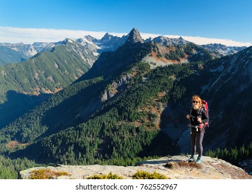 A Woman Hiker Admires Mountain Views in Snoqualmie Pass. 
Central Cascades, Washington.