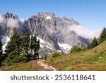 A Woman Hiker among Rocky Mountains on the Cascade Pass Sahale Arm Trail
North Cascades National Park, Washington.