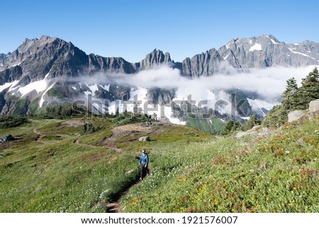 A Woman Hiker among Rocky Mountains on the Cascade Pass Sahale Arm Trail
North Cascades National Park, Washington.