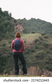 Woman Hiker From Behind Contemplating The Views Of The Landscape.