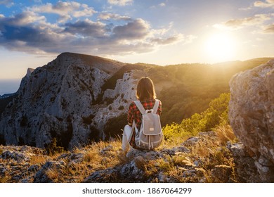 Woman Hiker Enjoy The View At Sunset Mountain Peak Cliff. Idea Of Ecotourism Travel. Discovery Travel Destination Concept