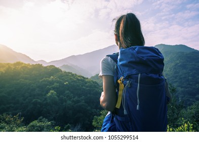 woman hiker enjoying the view on morning mountain valley