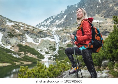Woman hiker, hiking backpacker traveler camper walking on the top of mountain in sunny day under sun light. Beautiful mountain landscape view.