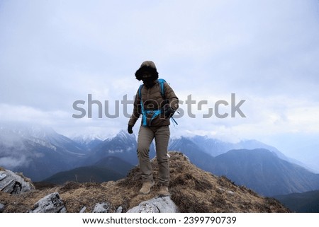 Woman hiker hiking at mountain top in tibet