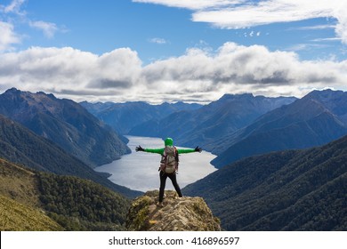 Woman hiker on mountain cliff. Kepler Track, New Zealand - Shutterstock ID 416896597