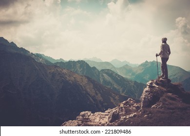 Woman hiker on a top of a mountain  - Shutterstock ID 221809486