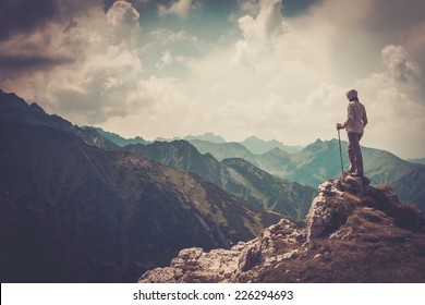 Woman hiker on a top of a mountain  - Shutterstock ID 226294693