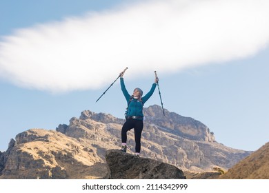 Woman Hiker Portrait. She Is Standing On A Mountain Peak, Looking At Nature Landscape