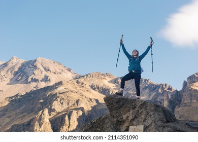 Woman Hiker Portrait. She Is Standing On A Mountain Peak, Looking At Nature Landscape