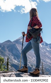 Woman Hiker In Red Flannel Shirt Standing At Top Of Rocky Mountains Colorado