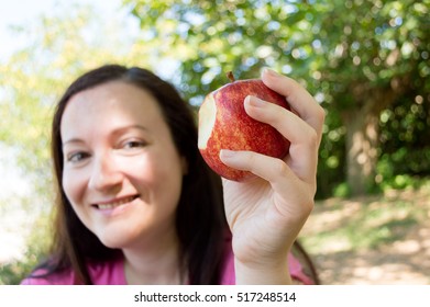 woman hiker resting and eating an apple sitting