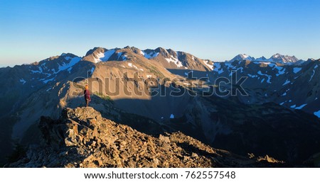 A Woman Hiker and Rocky Mountains at Sunset. Olympic National Park, Washington