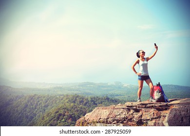 Woman Hiker Taking Photo With Smart Phone At Mountain Peak,vintage Effect