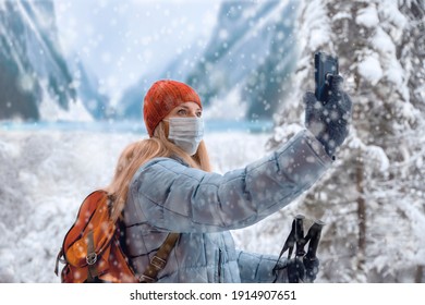 Woman Hiker Taking A Selfie Photo, Using Mobile Phone In Beautiful Nature On Winter Day. Woman With Face Mask Take A Selfie Picture On Cold Day On Hiking In Mountains. Copy Space