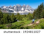 A Woman Hiker Walks Along the Trail Above Amethyst Lake in The Rampart Mountains. Tonquin Valley, Canadian Rockies, Alberta Canada.