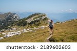 Woman hiking the Chartreuse moutains, in the French Alps, near the Dent de Crolles, Grenoble 