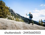 Woman hiking Eagle Lake trail. Emerald Bay in the distance. South Lake Tahoe. California. 