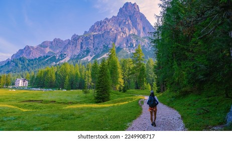 woman hiking in the Italian Dolomites, a Girl hiking to Lago Di Sorapis in the Italian Dolomites Italy, woman mid age Asian walking in the mountains with a backpack