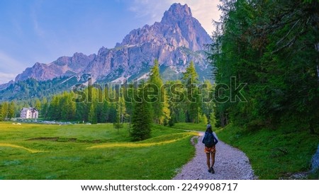 woman hiking in the Italian Dolomites, a Girl hiking to Lago Di Sorapis in the Italian Dolomites Italy, woman mid age Asian walking in the mountains with a backpack Foto d'archivio © 