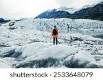 Woman is hiking on Matanuska Glacier near Glenn Highway in Alaska. High quality photo