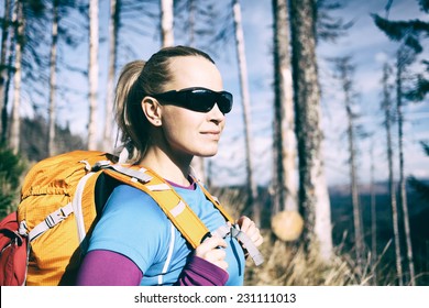 Woman Hiking On Trail In Forest. Vintage Retro Old Style Recreation And Healthy Lifestyle Outdoors In Nature. Beauty Blond Hiker With Backpack Looking At Mountains View.