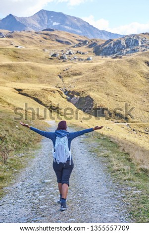 Woman hiking on a trail in the valley "Weitental" in the Alps of Tux in Austria