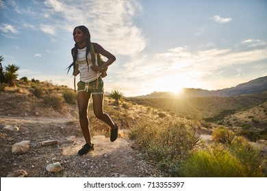 Woman Hiking At Red Rock Canyon During Sunset With Backpack