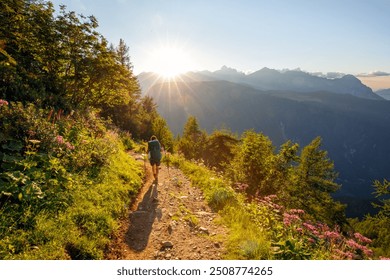 Woman hiking solo with big backpack, sunset and mountains on background - Powered by Shutterstock