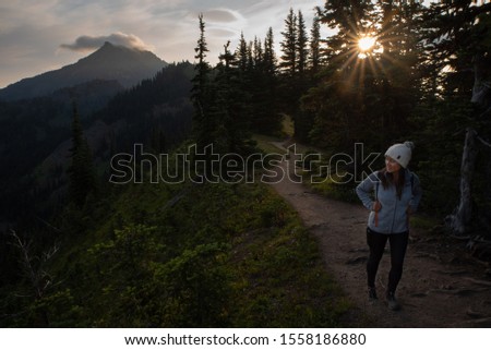 Woman hiking at sunrise at Olympic National Park in Washington USA