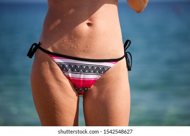 Woman Hips And Stomach In Color Panties.
Close Up Goosebumps And Drops Of Water Woman At The Beach, Menstruation