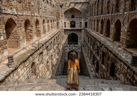 Woman at historic stepwell Agrasen Ki Baoli in Delhi India. 108 steps