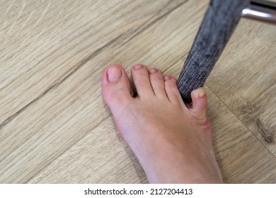 Woman hit furniture with the little toe. Incident at home. Injury of foot little finger - Shutterstock ID 2127204413