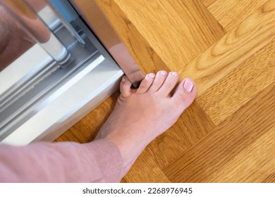 Woman hit furniture with the little toe. Incident at home. Injury of foot little finger - Shutterstock ID 2268976945