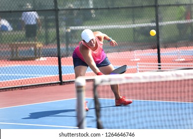 A Woman Hits A Shot Playing Pickleball