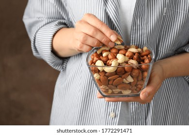 Woman hold bowl with different nuts. Healthy eating - Powered by Shutterstock