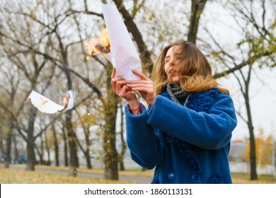 Woman Hold Burning Paper With Flying Ash