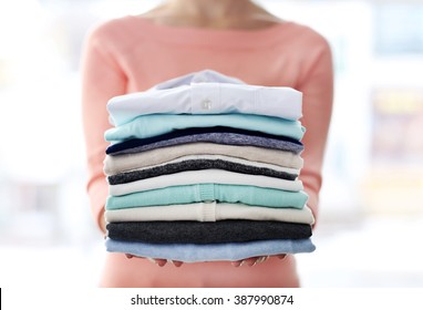 Woman Hold Clothes Pile, Close Up