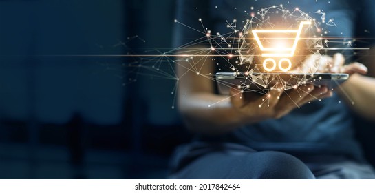 Woman hold digital tablet online shopping to digital cart with global network connection. Intelligent E-commerce app, internet banking payment and financial technology enable lifestyle convenience. - Shutterstock ID 2017842464