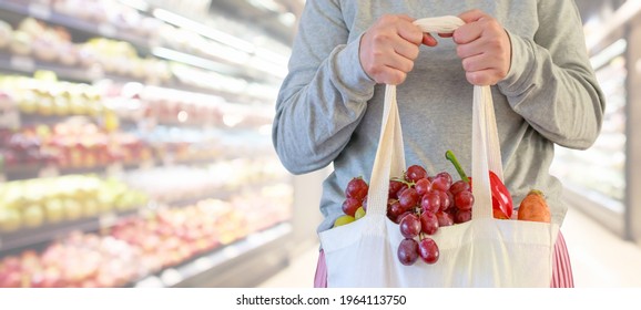 Woman hold grocery shopping bag in supermarket