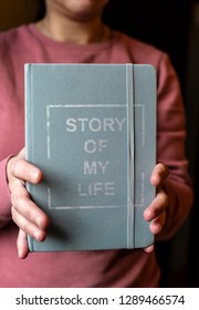 Woman Hold Notebook. Book Notes For The Story Of My Life. Personal Memoirs Notes Concept. Hands Hold Book.