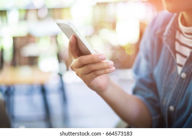 Woman Hold With Smart Phone At Coffee Shop