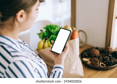 Woman hold the smartphone with white screen, mock up. Online food market concept.