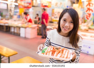 Woman Hold A Snow Crab In Fish Market