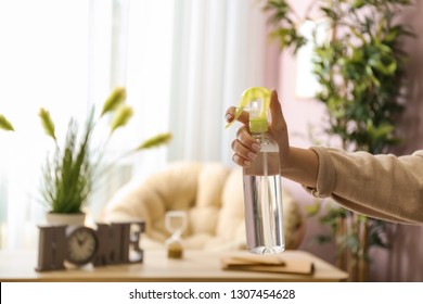 Woman Holding Air Freshener At Home