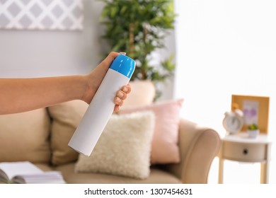 Woman Holding Air Freshener At Home