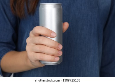 Woman holding aluminum can, closeup. Space for design
