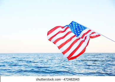 Woman Holding American Flag On Beach